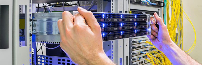 Installation of a new server in a rack with computer equipment.