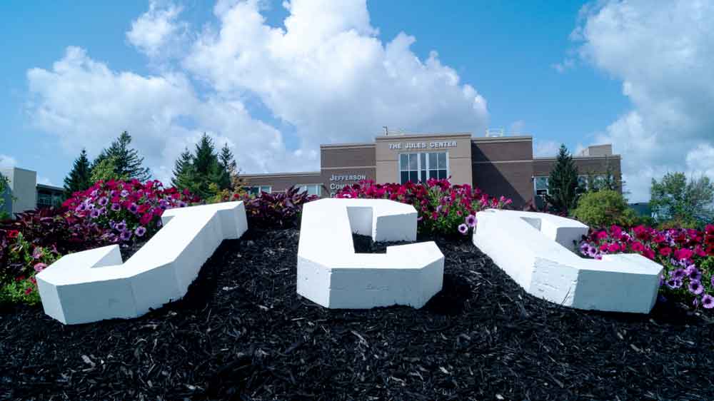 Cement letters on campus spelling out JCC